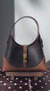 Creator styling video featuring the Xiangyunsha Plum and Bamboo handbag with a modern denim outfit outdoors brocademodern