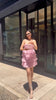 Creator styling a pink Chinese embroidered handbag with a feminine summer outfit outdoors brocademodern