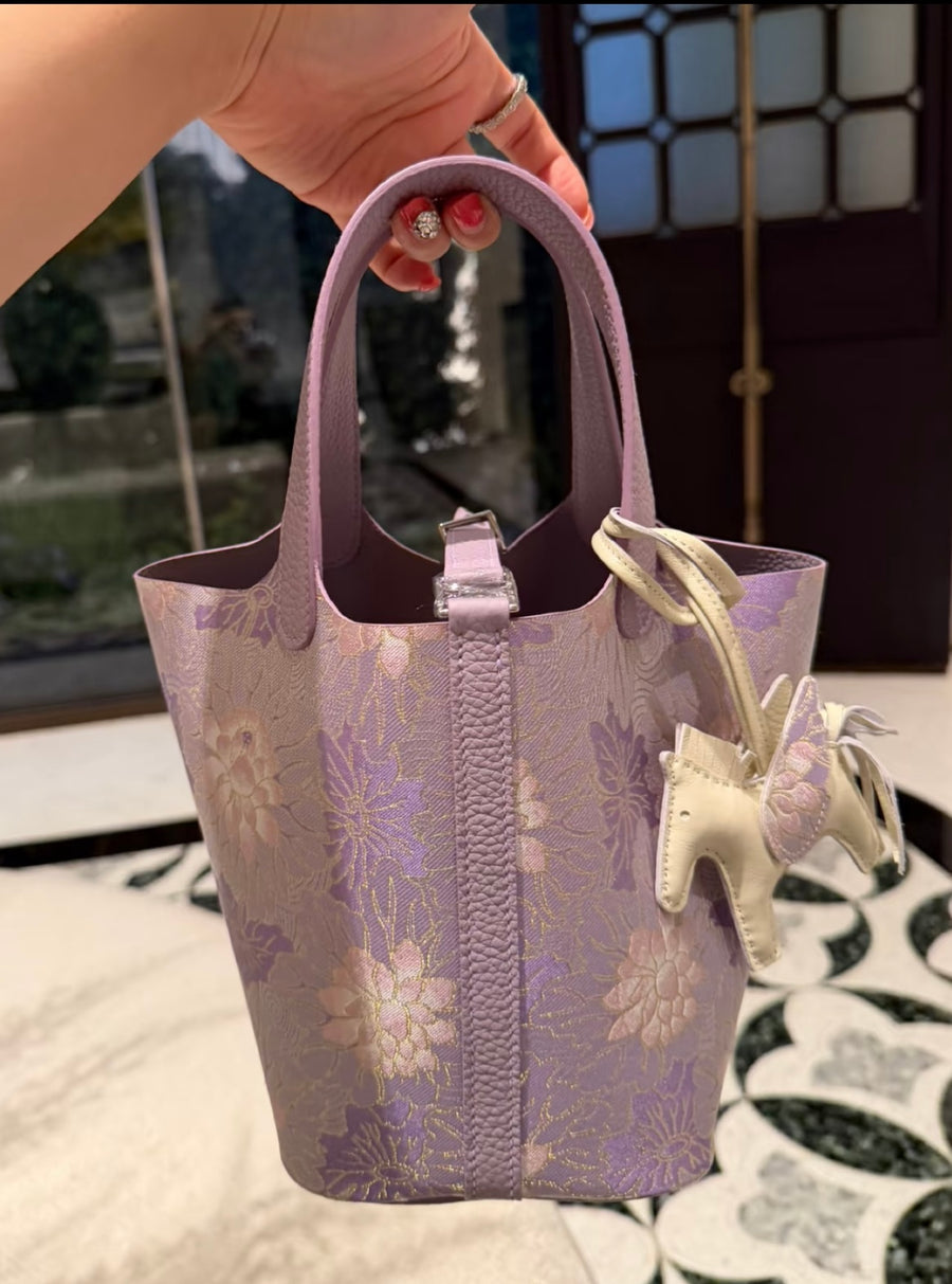 Purple Rippling Water Chinese Song Brocade handbag with lilac leather handles, floral woven pattern, and a delicate horse charm brocademodern