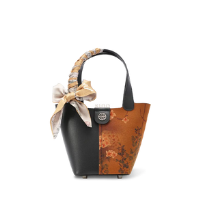 Front view: Xiangyunsha silk handbag with plum blossom embroidery.